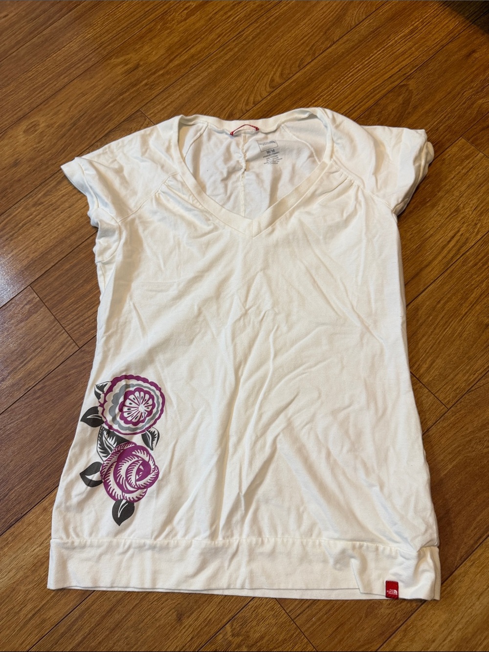 The North Face White V-Neck Tee with Purple Floral Accent Size Medium